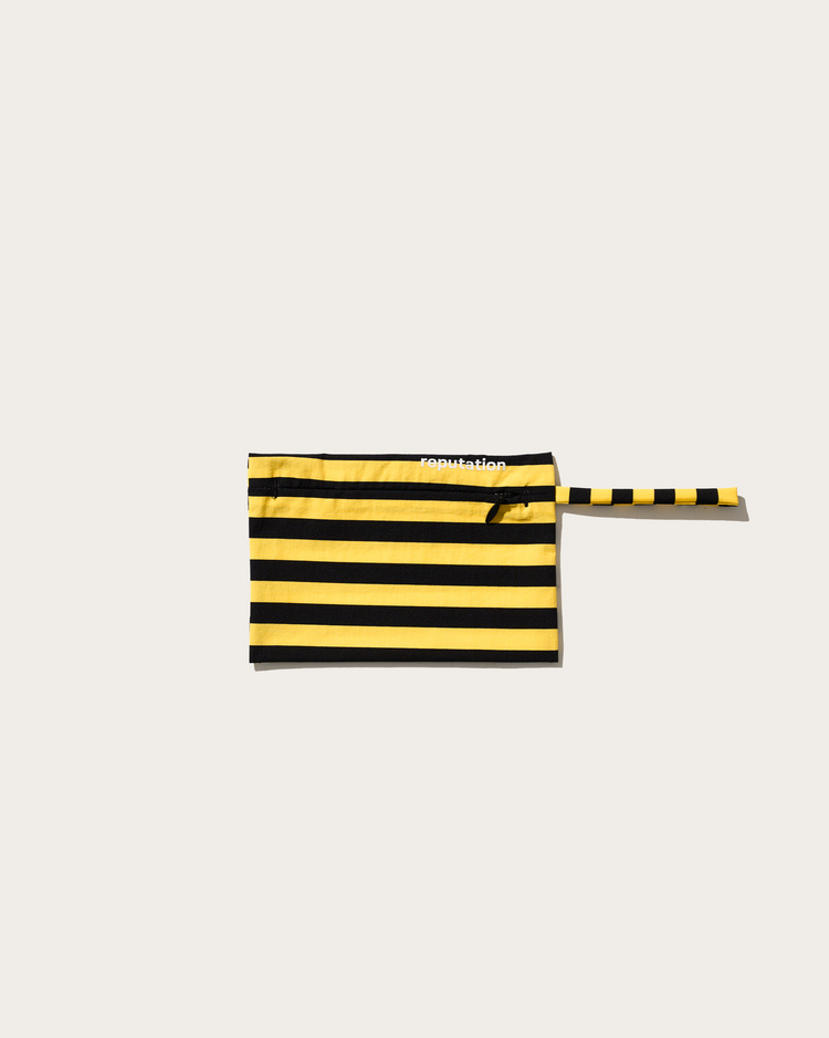 Reputation yellow and black stripe swimwear pouch, flat lay