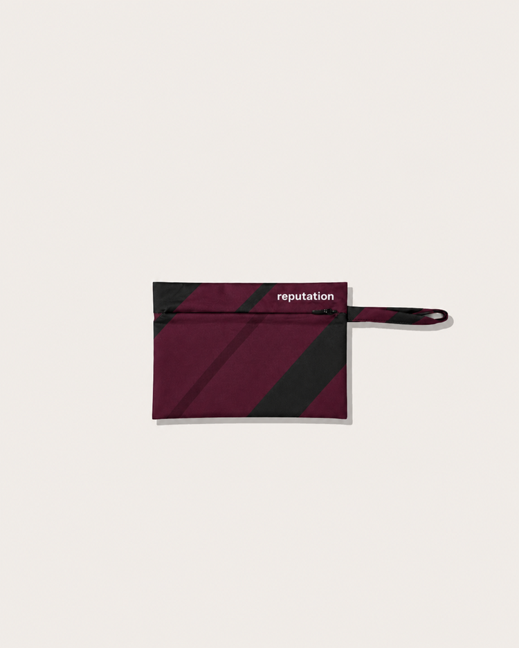 Reputation Vector print swimwear packaging pouch in purple, flat lay